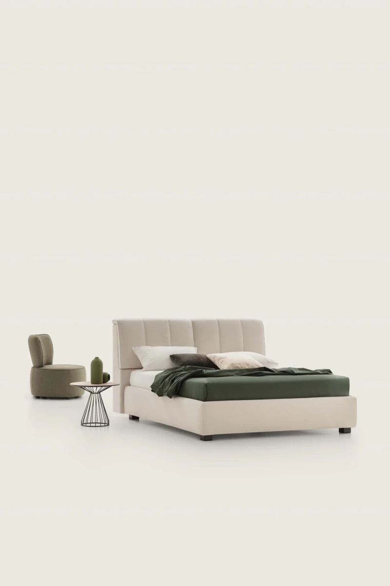 Inside — Bed with a tufted headboard and a built-in storage compartment.