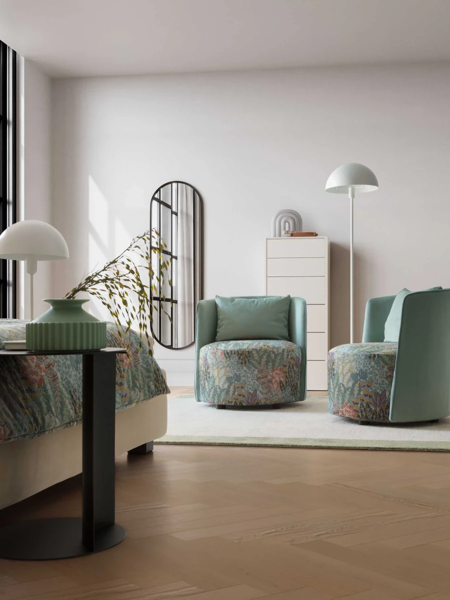 Isabel — Round-based barrel-like design armchair with a sleek backrest and perimeter stitching.