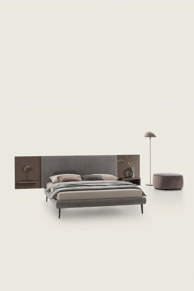 Wall — Contract bed with a simple, smooth padded headboard and side shelves.
