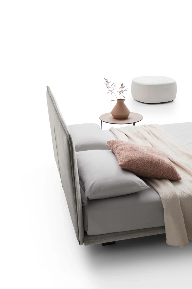 Vasco — Space-saving bed with a smooth padded headboard and piping detail.