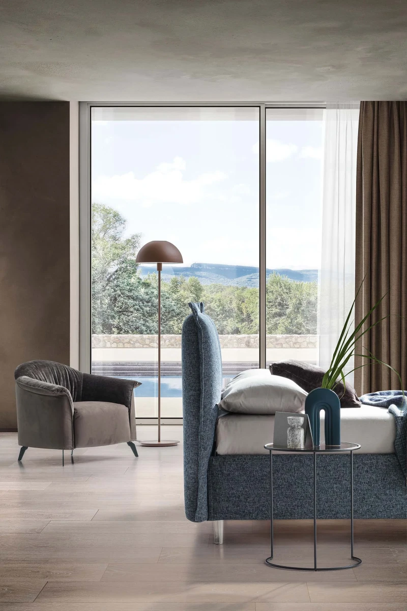 Catlin — Bed with a headboard composed of padded cushions with wide borders.
