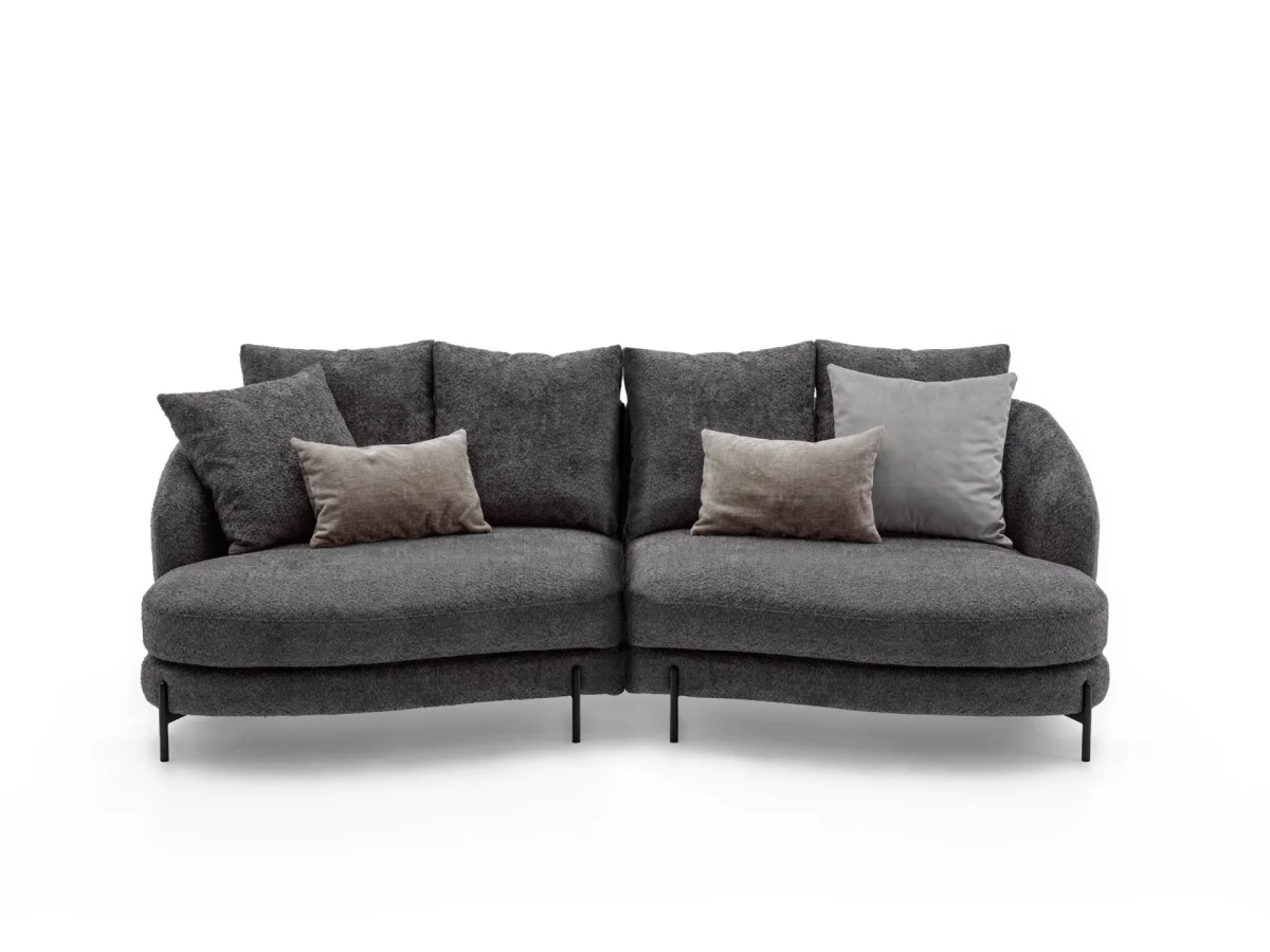 Jand — Sofa with organic shapes, high legs, round end modules, and shaped seats