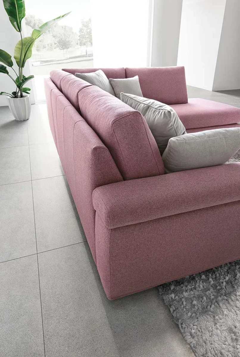 Papilio — Sofa with extendable footrest, rounded armrests, and asymmetrical corner seating.
