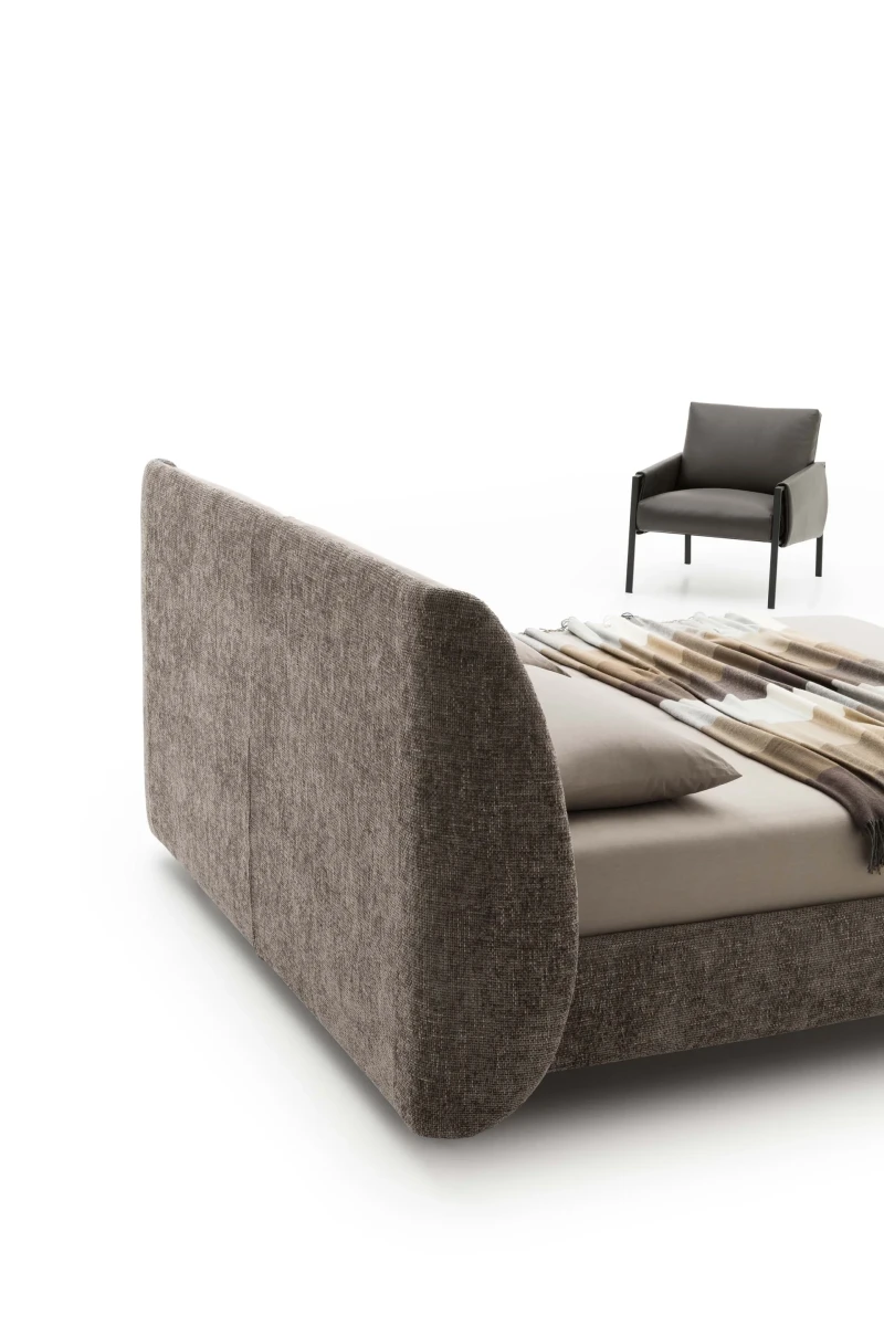 Timoty — Wingback bed with a padded structure.