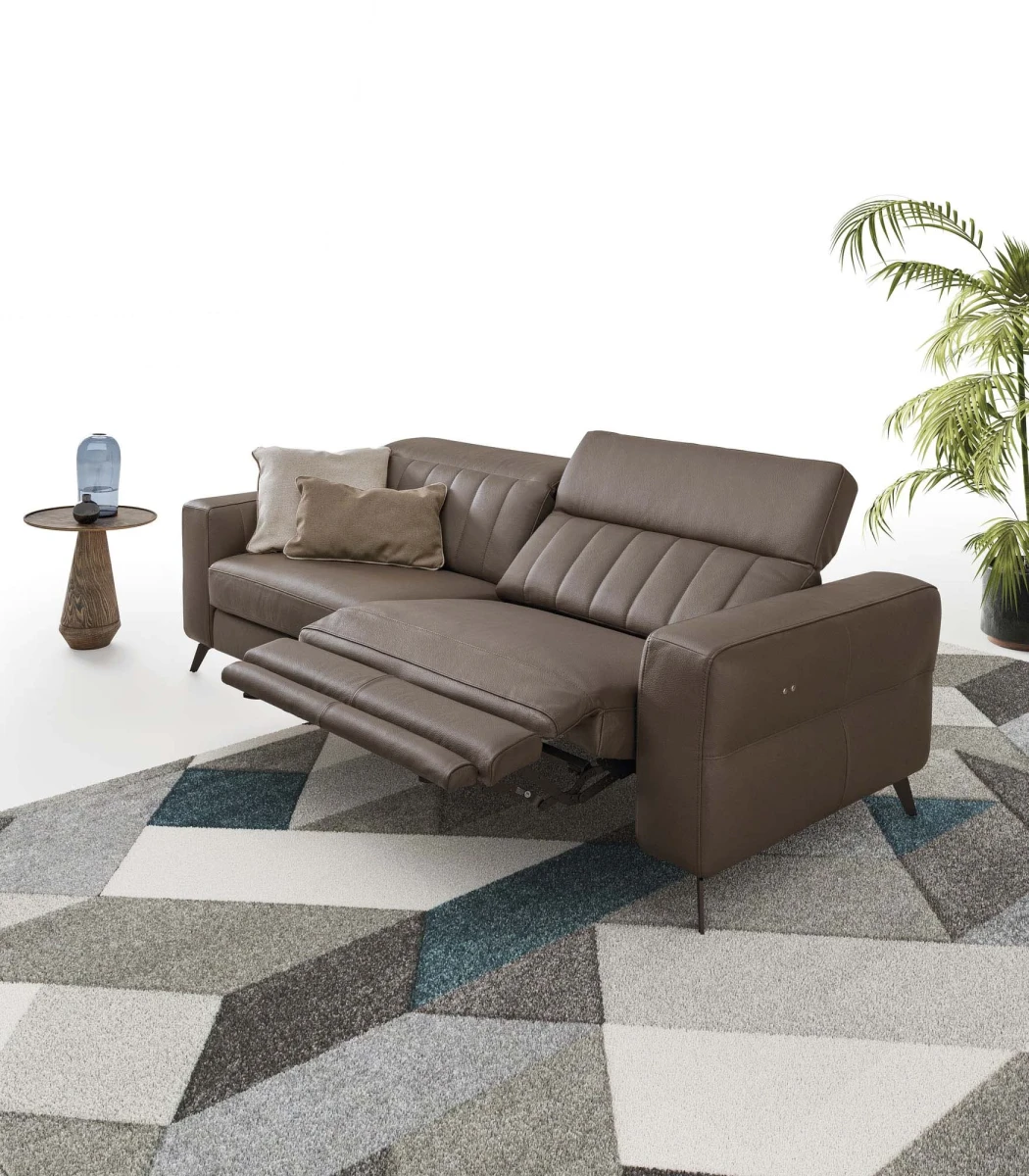Egon — Recliner sofa with adjustable headrests, and vertically stitched backrest.