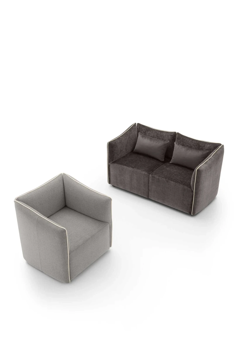 Kubik — One-piece frame armchair with a cubic shape and visible bicolor edges.