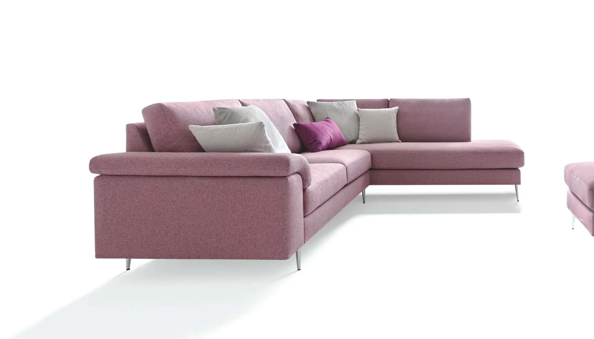 Papilio — Sofa with extendable footrest, rounded armrests, and asymmetrical corner seating.
