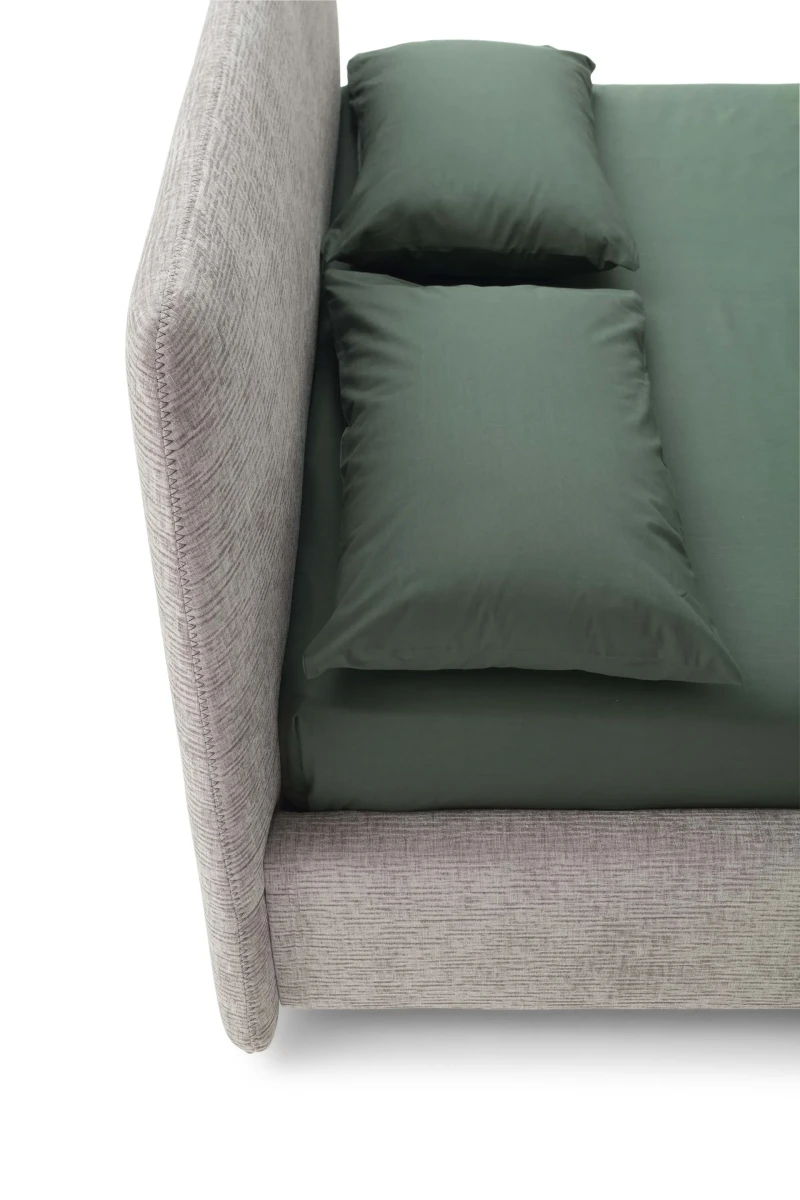 Calvin — Bed with a simple design featuring a softly rounded and smooth upholstered headboard.