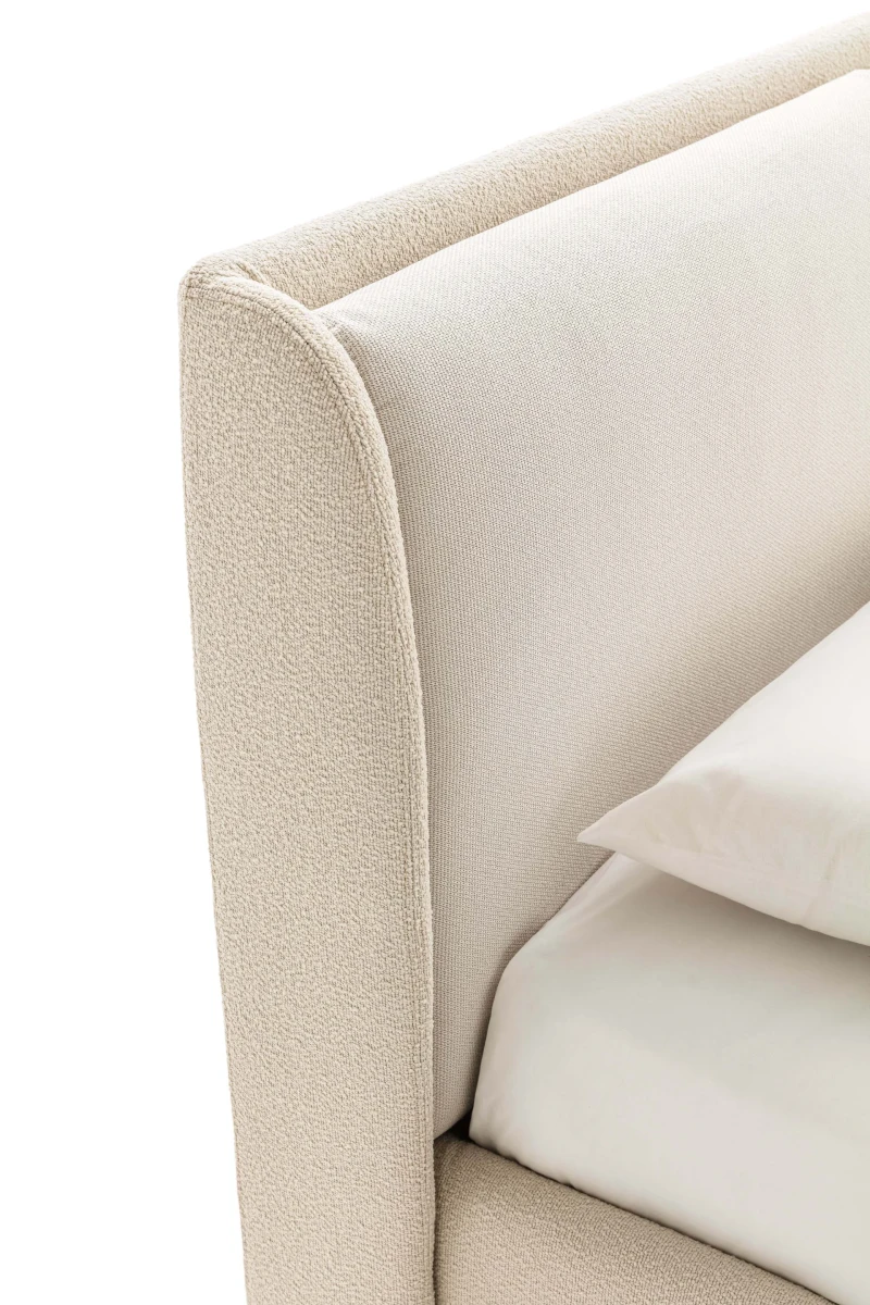 Windsor — Bed with a padded headboard composed of two delicately designed cushions.