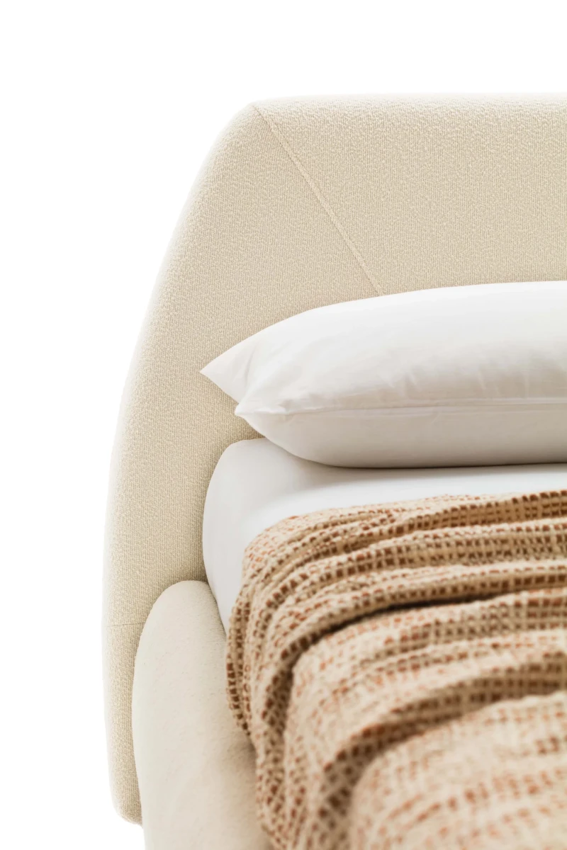 Belmondo — Bed with a rounded headboard and stitching that resembles an envelope.