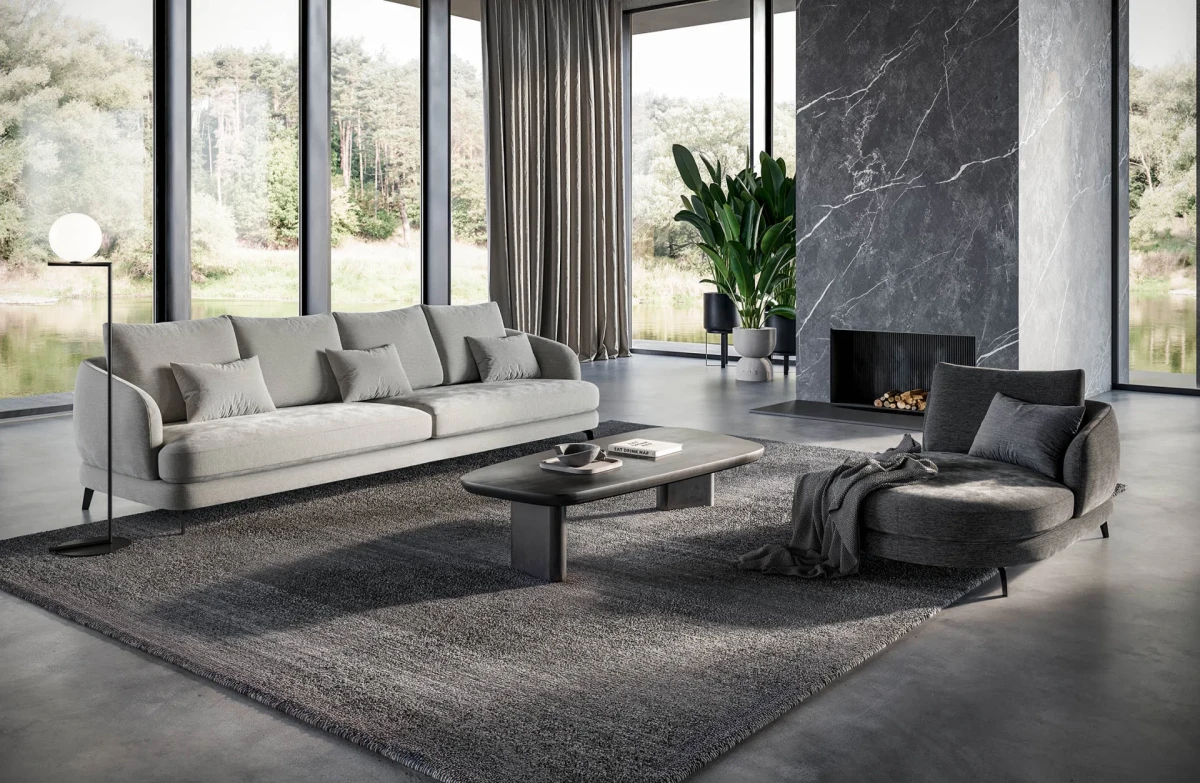 Jand — Sofa with organic shapes, high legs, round end modules, and shaped seats