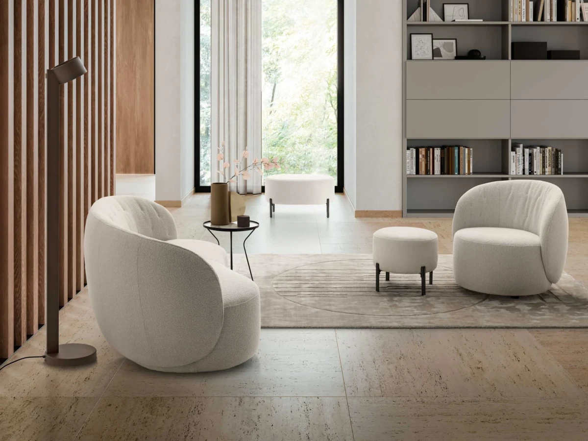 Moby — Rounded one-piece frame armchair with a quilted backrest and optional fixed or swivel base.