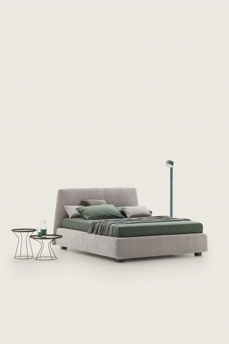 Calvin — Bed with a simple design featuring a softly rounded and smooth upholstered headboard.