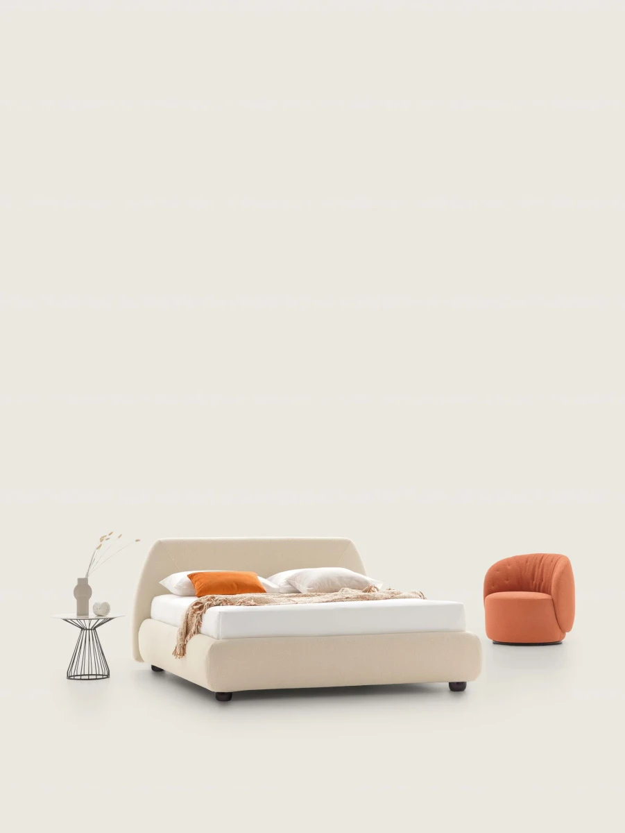 Belmondo — Bed with a rounded headboard and stitching that resembles an envelope.
