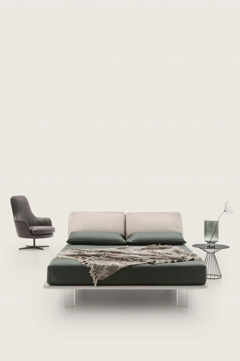 Fenice — Bed with a headboard made of soft upholstered cushions.