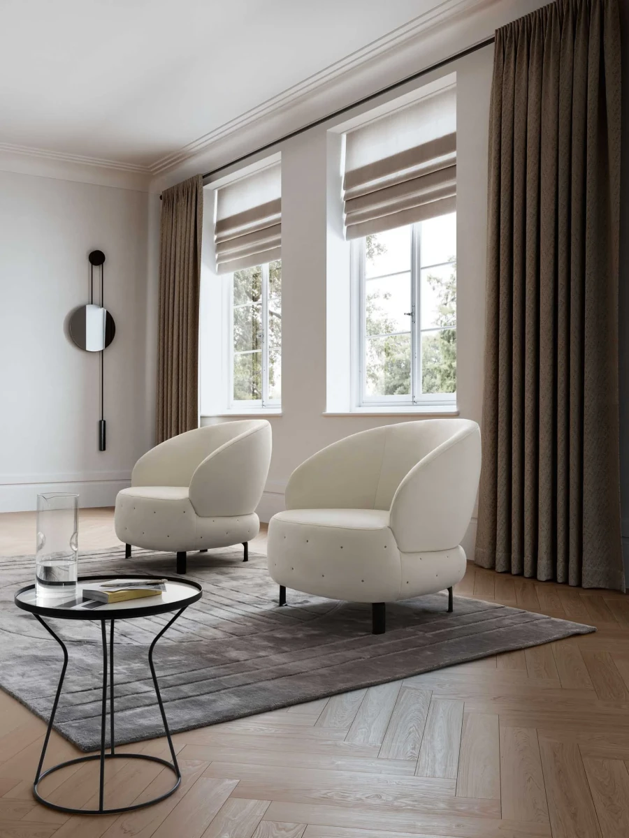 Guapa — Eccentric armchair with a quilted, rounded base and curved backrest.