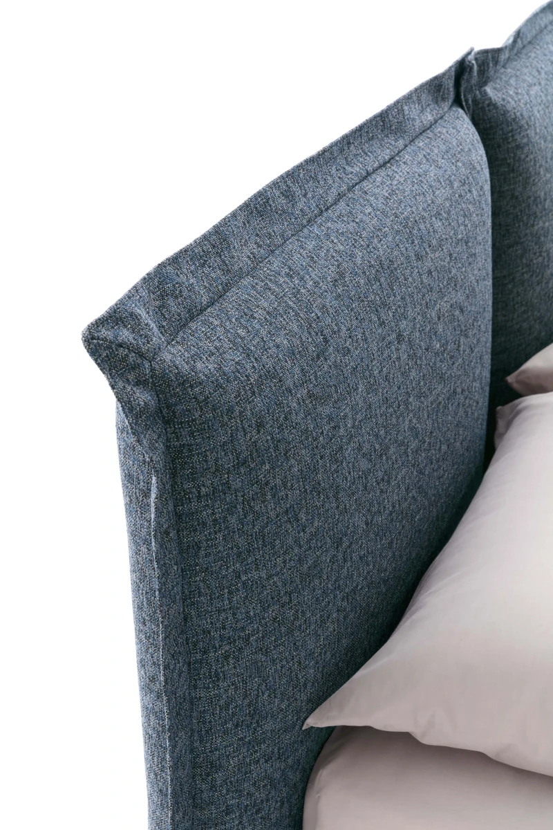 Catlin — Bed with a headboard composed of padded cushions with wide borders.