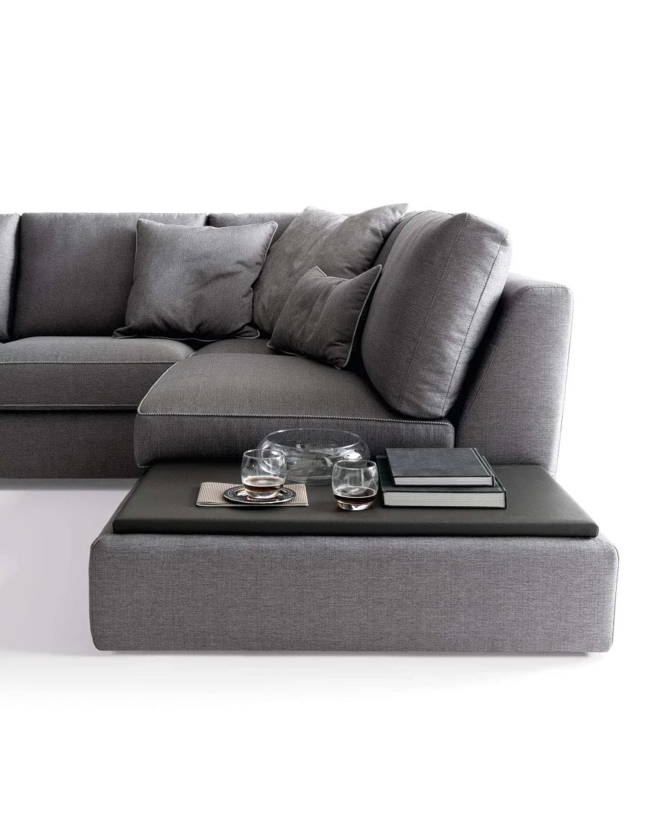 Magyster — Sofa with visible stitching and integrated side shelf.