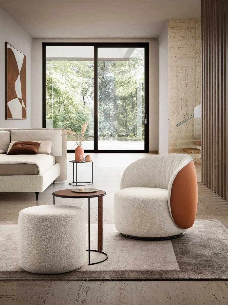 Moby — Rounded one-piece frame armchair with a quilted backrest and optional fixed or swivel base.
