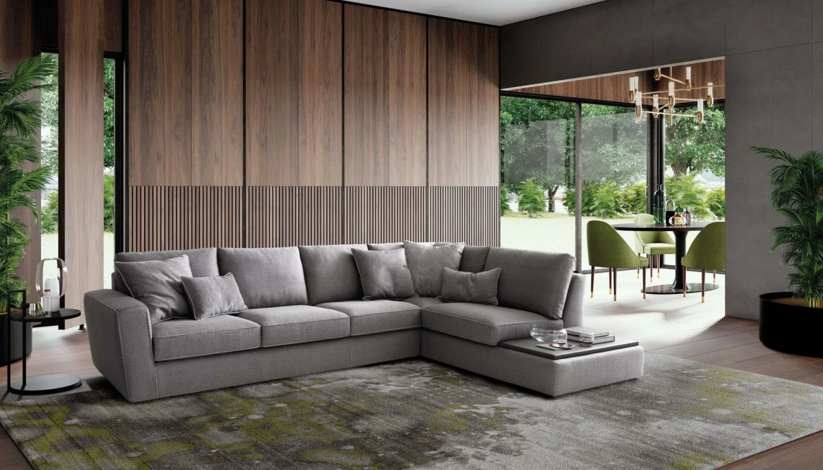 Magyster — Sofa with visible stitching and integrated side shelf.