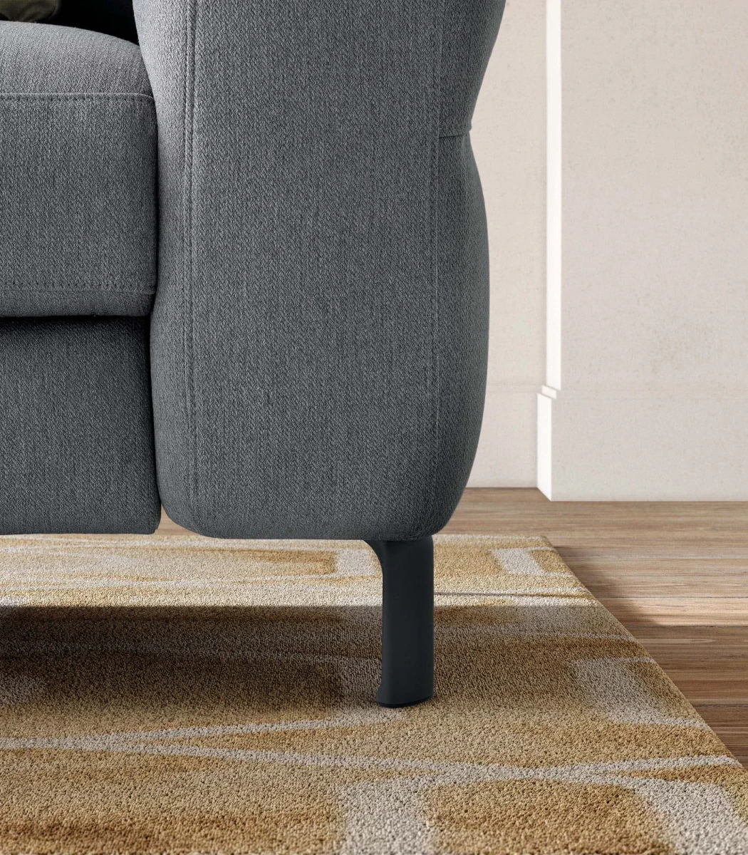 Egon — Recliner sofa with adjustable headrests, and vertically stitched backrest.