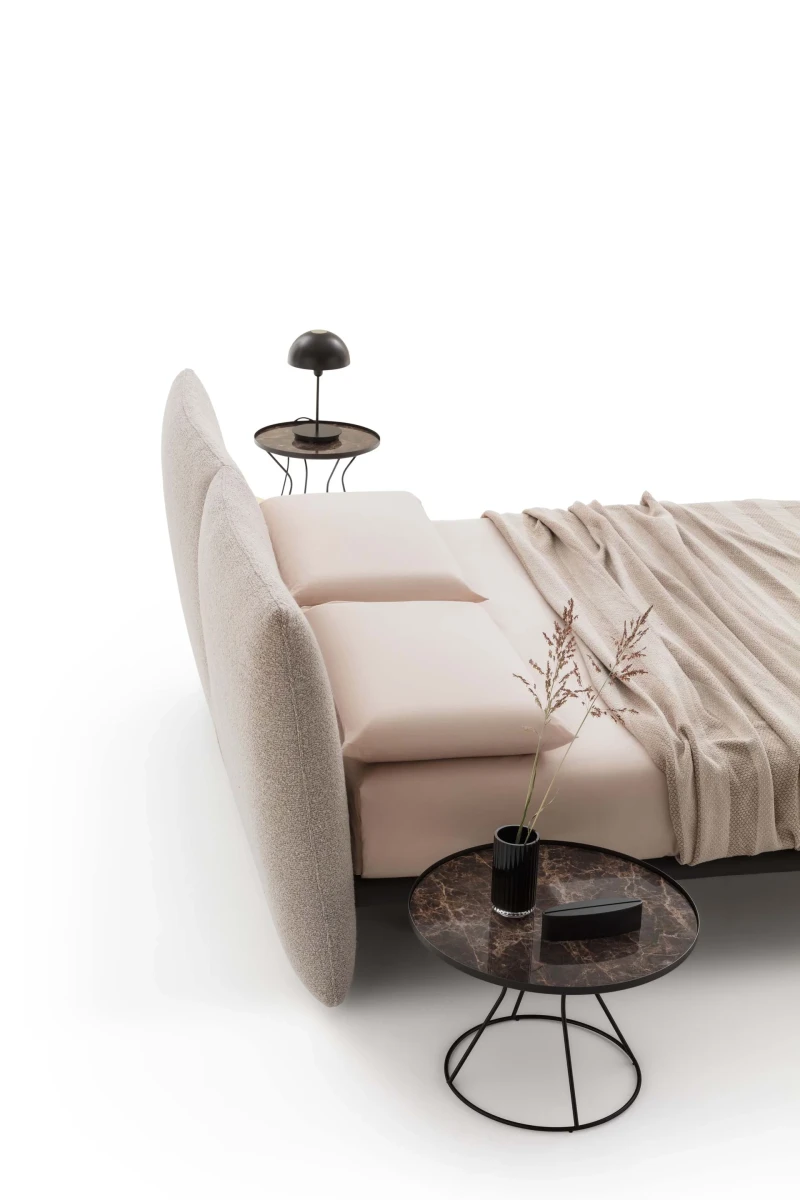 Monaco — Modern bed with a large headboard composed of upholstered cushions.