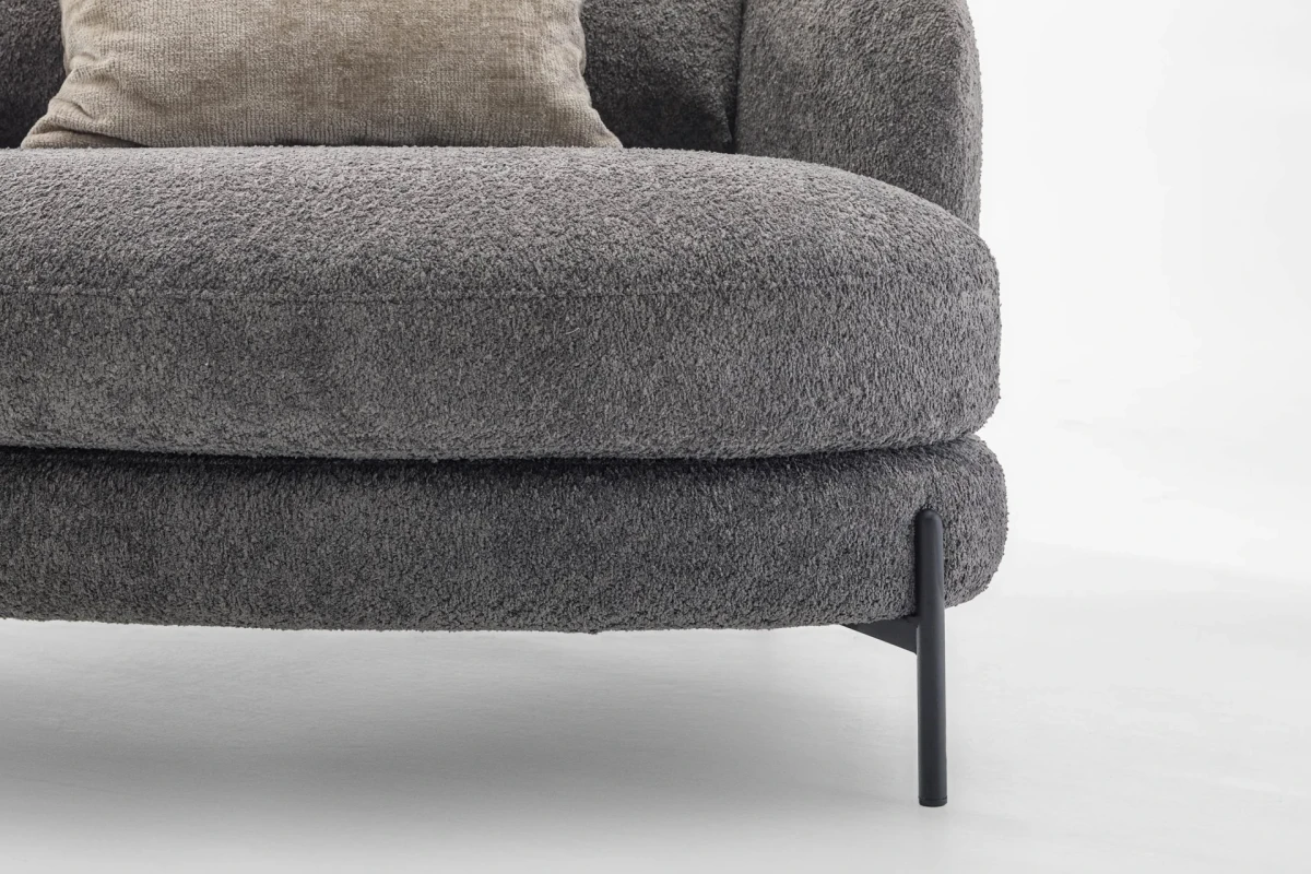 Jand — Sofa with organic shapes, high legs, round end modules, and shaped seats