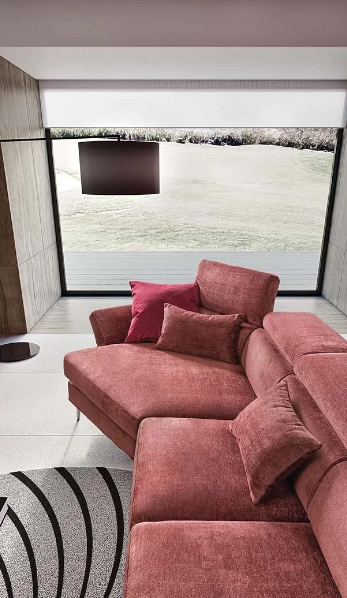 Aurora — Sofa with asymmetrical corner seating, adjustable headrests and armrests, and extendable footrest mechanism.
