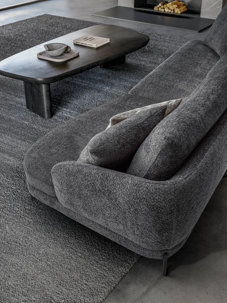 Jand — Sofa with organic shapes, high legs, round end modules, and shaped seats