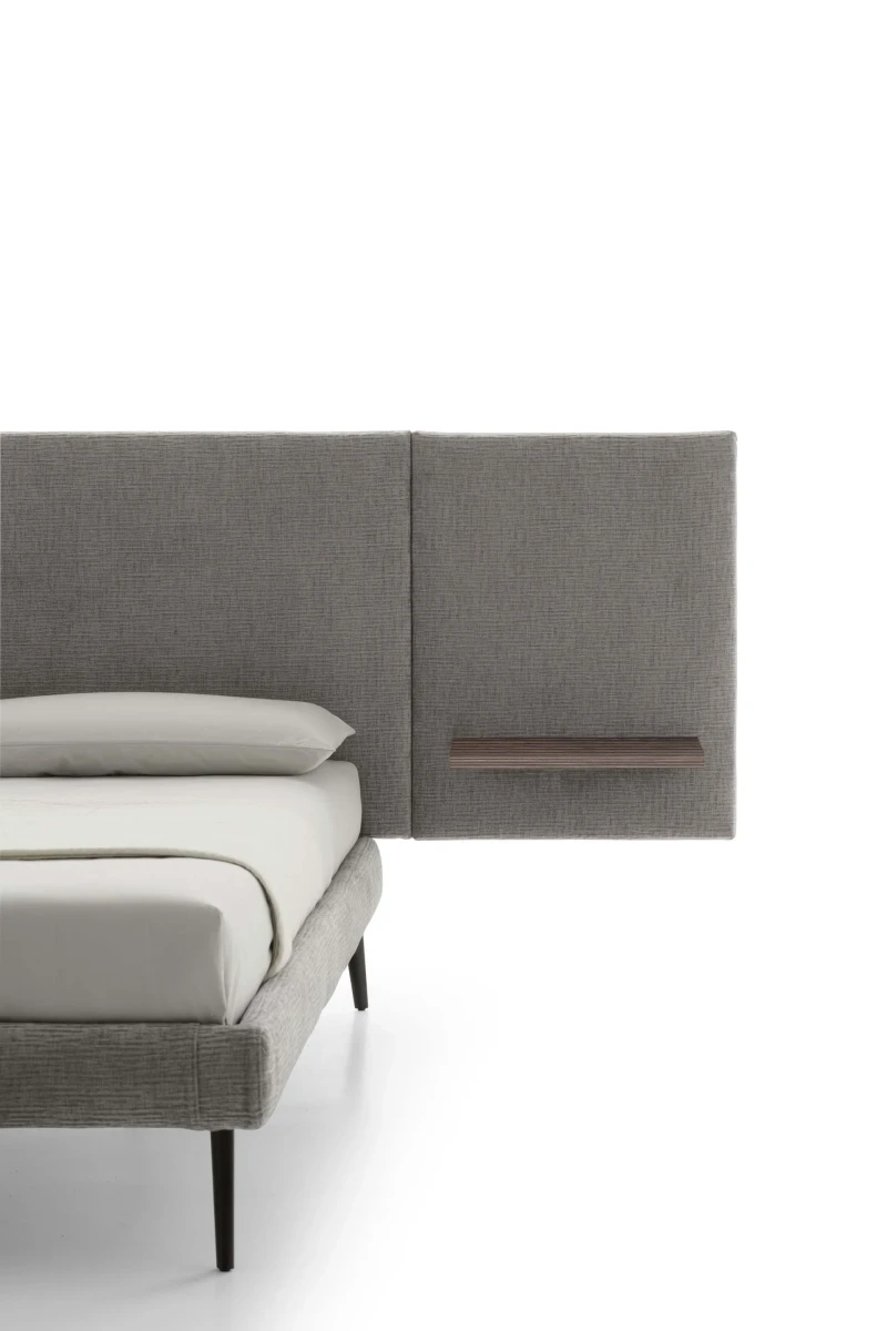 Wall — Contract bed with a simple, smooth padded headboard and side shelves.