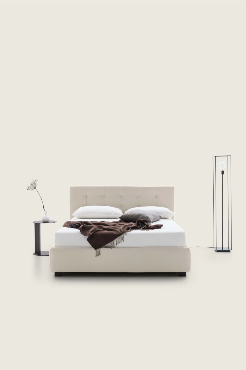 Tender — Modern squared bed with light tufting on the headboard.