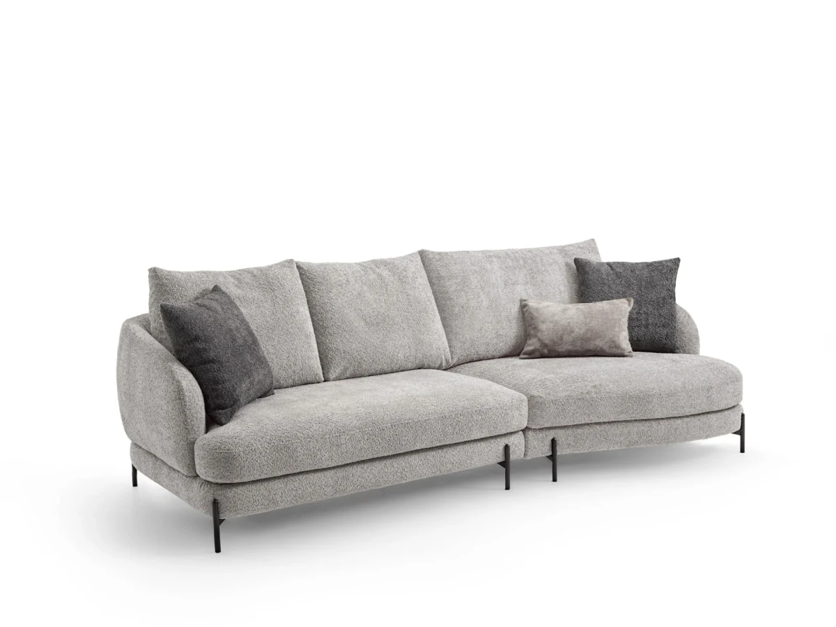 Jand — Sofa with organic shapes, high legs, round end modules, and shaped seats