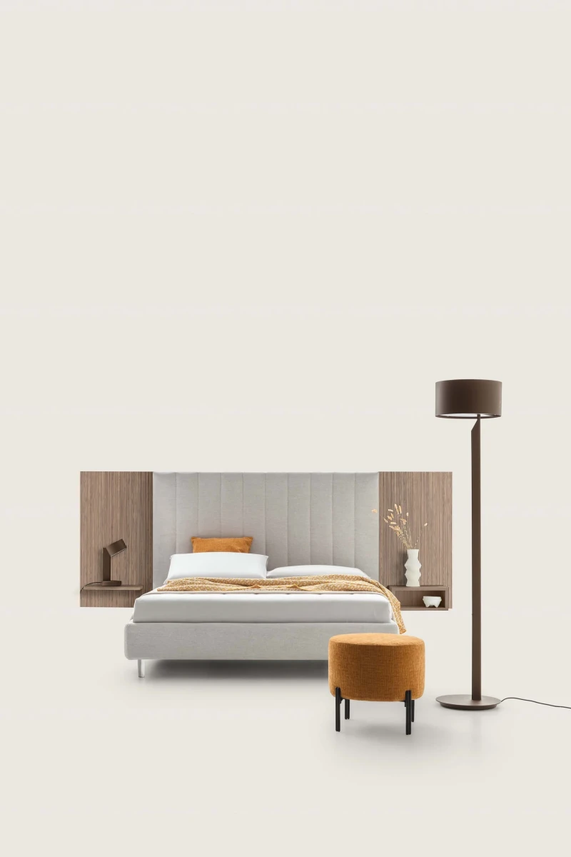 Tile — Contract bed with a vertical padded headboard and side panels with built-in shelves.