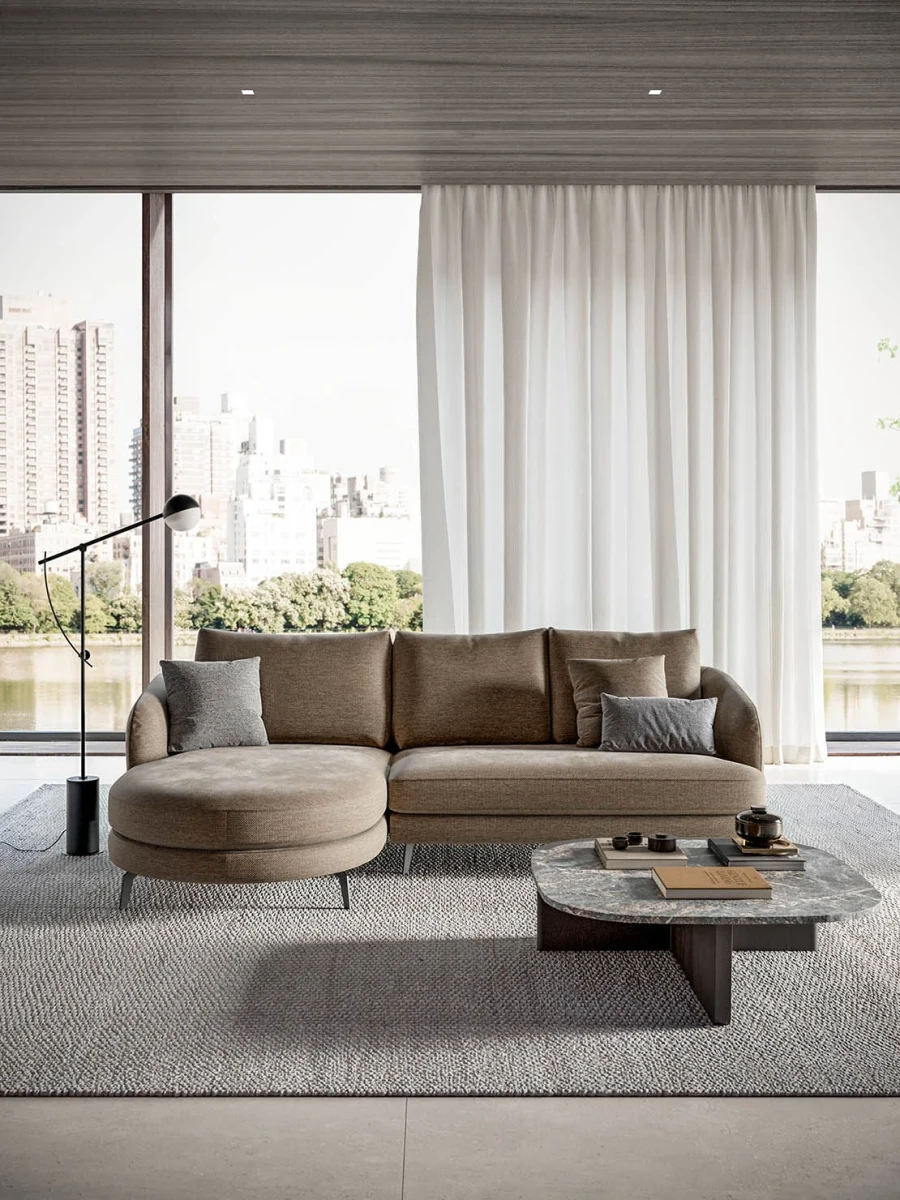 Jand — Sofa with organic shapes, high legs, round end modules, and shaped seats