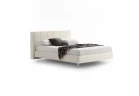 Gaucho — Bed with a squared headboard featuring a quilted square motif.