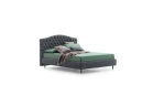 Renoir — Classic-style bed with a tall, curved headboard featuring full-width tufting.