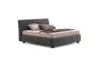 Break — Bed with a smooth, simple headboard and visible stitching.