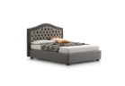 Dama — Classic-style bed with an arched tufted headboard.