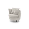 Privè — Elegant armchair with cushions resting on a slim, asymmetrical, and enveloping backrest.