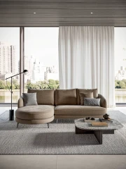Jand — Sofa with organic shapes, high legs, round end modules, and shaped seats