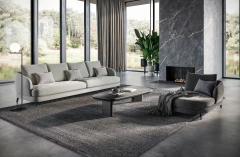 Jand — Sofa with organic shapes, high legs, round end modules, and shaped seats