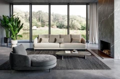 Jand — Sofa with organic shapes, high legs, round end modules, and shaped seats