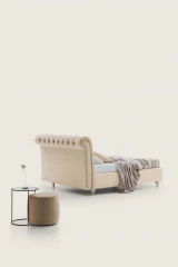 Raffaello — Classic-style bed with a rolled-top tufted headboard.