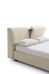 Inside — Bed with a tufted headboard and a built-in storage compartment.