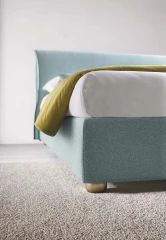 Hesperis — Space-saving bed with a simple, curved padded headboard.