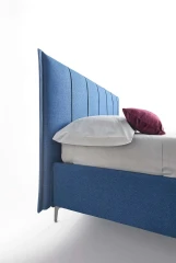 Plumeria — Space-saving bed with a vertically stitched padded headboard.