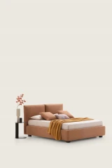 Allen — Comfortable bed with a headboard composed of large cushions with decorative piping.