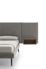 Wall — Contract bed with a simple, smooth padded headboard and side shelves.