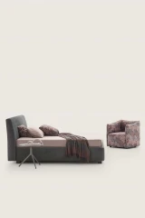 Break — Bed with a smooth, simple headboard and visible stitching.
