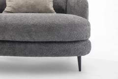 Jand — Sofa with organic shapes, high legs, round end modules, and shaped seats